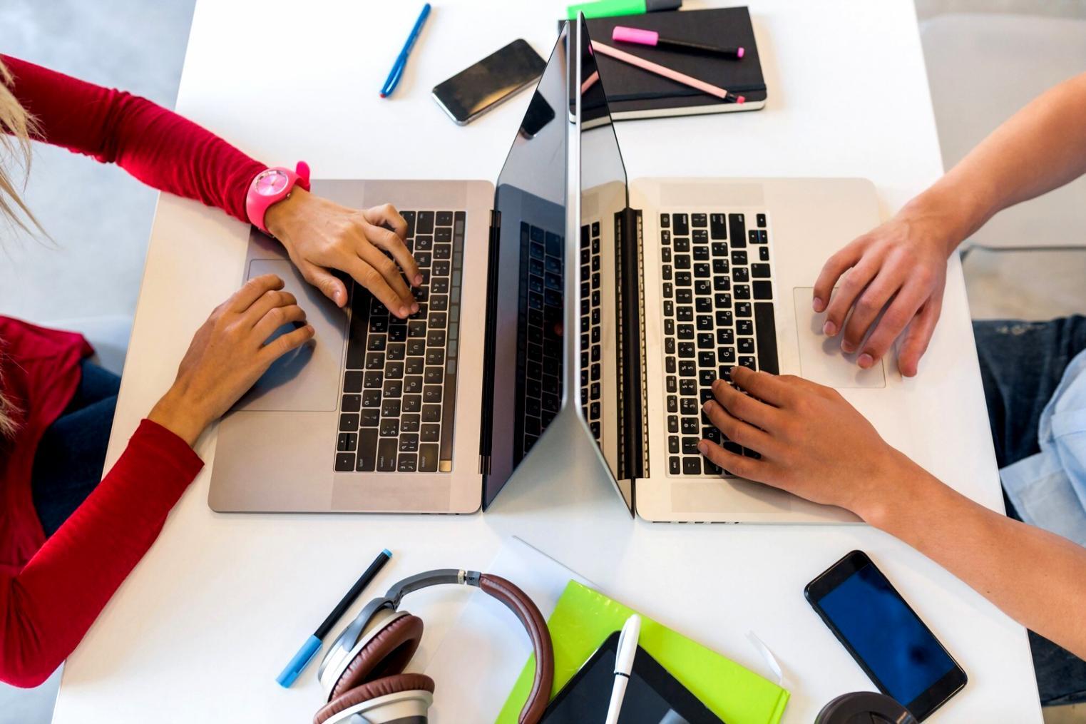 Students learning budget planning techniques in modern classroom setting